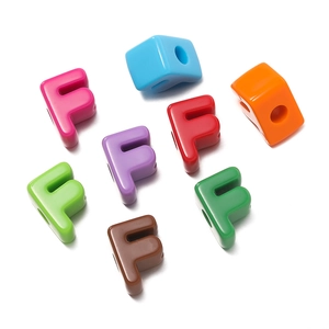 Macro shot of colorful acrylic letter F beads for DIY jewelry and bracelet making