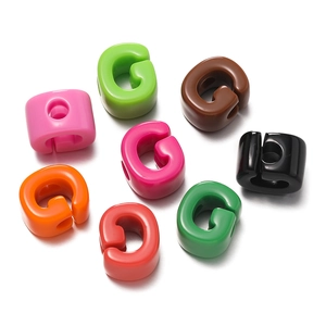 Detailed view of colorful G-shaped acrylic beads for DIY jewelry and hair accessories