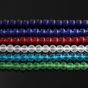 Macro view of multi-color frosted glass beads showing ice crackle texture on black background