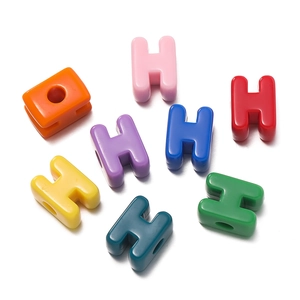 Macro detail of colorful H-shaped acrylic letter beads for DIY jewelry making