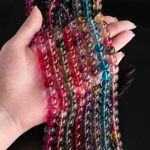 Vibrant natural tourmaline crystal beads strands shown against a dark black background