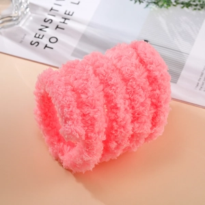 Close-up of pink coral fleece plush strip with soft texture for DIY craft headband