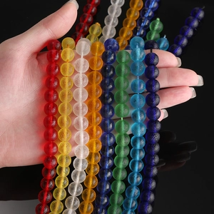 Hand holding vibrant 6/8/10mm frosted glass beads for DIY jewelry making and bead crafts