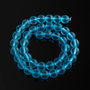 Macro shot of 8mm frosted sky blue glass beads with textured finish for DIY jewelry