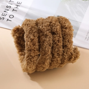 Close-up of 2cm thick brown plush chenille stem with soft coral fleece texture for DIY crafts