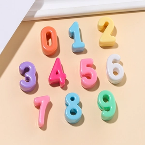 Macro detail of colorful 0-9 acrylic number beads with polished macaron finish for DIY