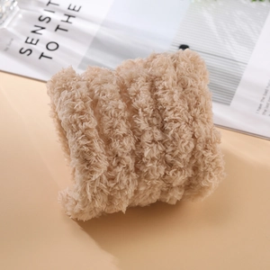 Macro shot of 2cm thick beige plush fabric showing dense coral fleece texture
