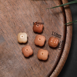Carved flower-shaped bodhi beads in apricot and orange for DIY jewelry making