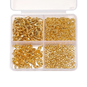 Golden jewelry DIY starter kit with lobster clasps and jump rings in a four-grid box