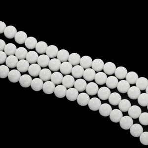 Polished 4-10mm white ceramic round beads for DIY jewelry making on black background