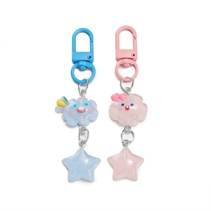 Cute resin star and cloud keychains in pastel blue and pink colors with glitter stars