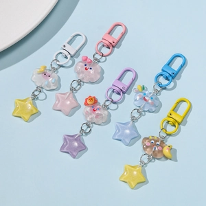 Detail of colorful resin star keychains with glitter and cloud weather charms