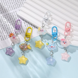 Detailed view of colorful resin star and cloud keychains in five pastel shades