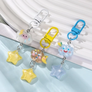 Detailed view of colorful resin star and cloud keychains with glittery finish and metal clasps