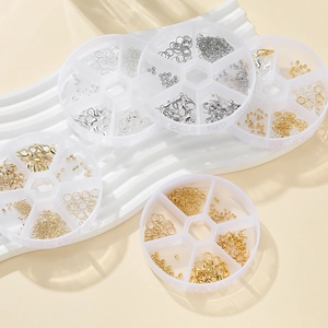 Detail of multi-grid storage boxes filled with gold and silver DIY jewelry components