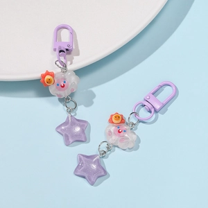 Detail of cute resin cloud and purple glitter star pendant with metal keychain