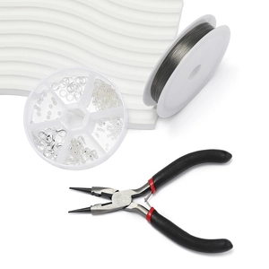 Close-up of DIY jewelry making kit with pliers, metal wire, lobster clasps and jump rings