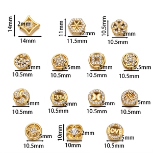 Macro detail of rhinestone-encrusted gold spacers in star, flower, and heart shapes