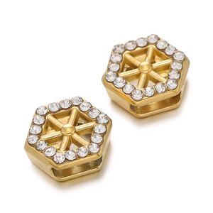 Close-up of hexagonal gold-plated spacer bead with embedded crystals and side hole for DIY