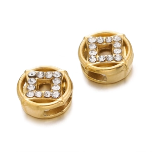 Macro view of gold stainless steel coin-shaped spacer beads with sparkling crystals