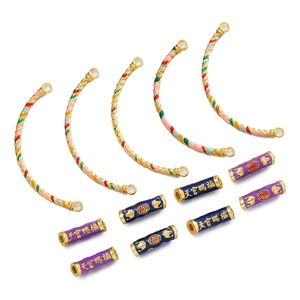 Detailed view of Cloisonne enamel beads and curved gold tubes with traditional patterns