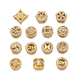 Detailed macro view of 15 gold-plated stainless steel spacer beads with sparkling rhinestones