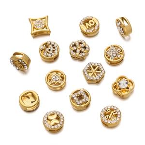Macro detail of gold stainless steel spacer beads with inlaid crystals for DIY jewelry