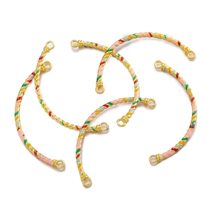 Detailed view of four colorful enamel curved tube connectors for DIY jewelry making