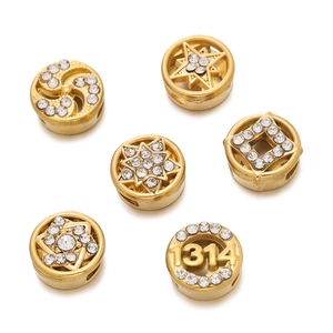 Detailed macro view of gold stainless steel spacer beads with crystal rhinestones for DIY jewelry
