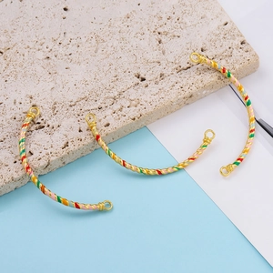 Detailed macro view of colorful enamel and golden twisted alloy tube jewelry parts