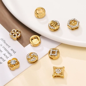 Golden sparkling spacer beads with white crystals and number 13 on soft aesthetic background