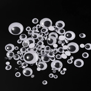 Detailed view of assorted sizes of black and white googly eyes for DIY craft projects