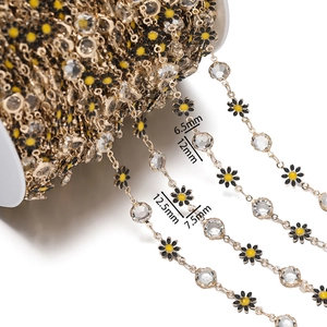 Detail view of 7.5mm daisy pendants and 6.5mm crystal beads on a gold diy jewelry chain