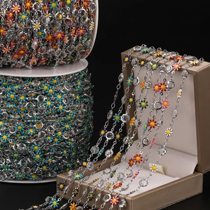 Detail of silver daisy chain with colorful enamel flowers and clear faceted crystal beads