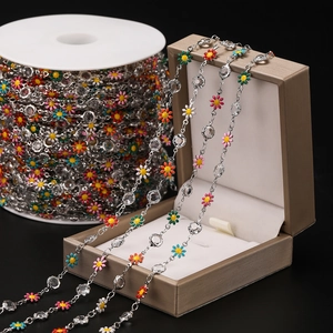Macro detail of colorful enamel daisy chain with sparkling crystals for DIY jewelry crafts