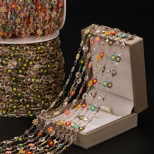 Close-up of colorful daisy flower chain with crystals and gold finish for DIY crafts