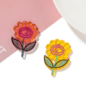 Detailed view of DIY acrylic flower charms with hand-painted graffiti patterns and pre-drilled holes