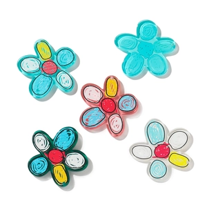 Detailed macro view of five colorful acrylic flower charms for DIY crafts and decor
