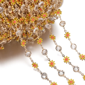 Detail of DIY golden daisy chain with enamel flowers and sparkling rhinestones