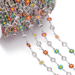 Macro view of colorful daisy enamel charms and faceted crystal beads DIY chain accessory