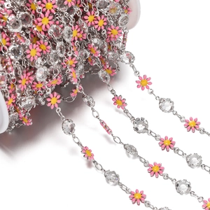 Macro shot of pink enamel daisy chain with crystal beads for DIY jewelry making