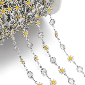 Detailed view of silver daisy chain with white enamel petals and faceted crystal beads