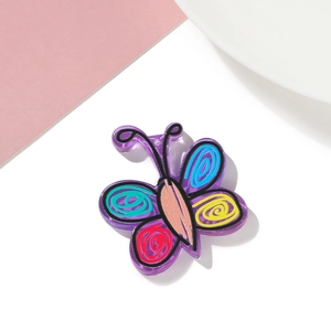 Detail of purple acrylic butterfly pendant with colorful floral patterns for DIY crafts