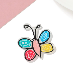 Detail of colorful hand-painted acrylic butterfly charm with spiral patterns and black edges