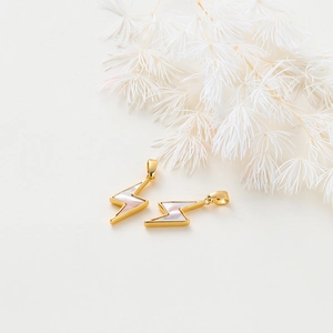 Macro detail of lightning shell pendants with 18K gold plating and iridescent luster