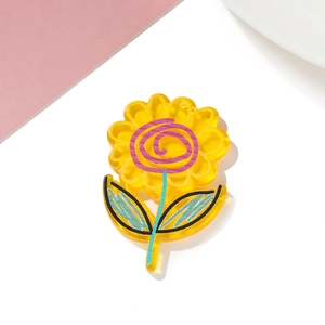 Close-up of yellow sunflower acrylic charm with hand-painted details for DIY crafts