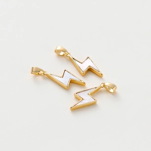 Detailed view of three gold-plated lightning bolt shell charms for DIY jewelry making