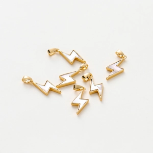 Macro view of five 14K gold-plated lightning bolt shell pendants for DIY jewelry making