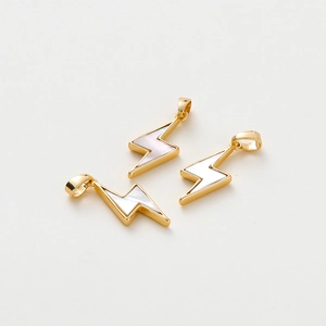 Detailed view of 18K gold lightning bolt pendants with white shell inlay for DIY jewelry