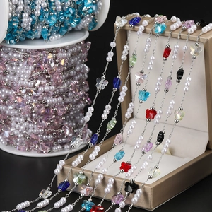 Detail of DIY pearl chain with colorful butterfly beads for handmade jewelry design